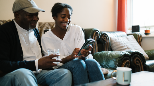Support for all - woman and man on couch with smartphone