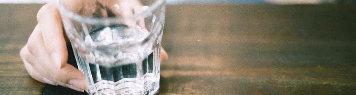 person holding a glass of water