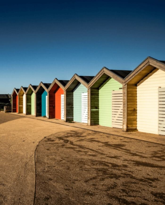 Beach huts on path near beach