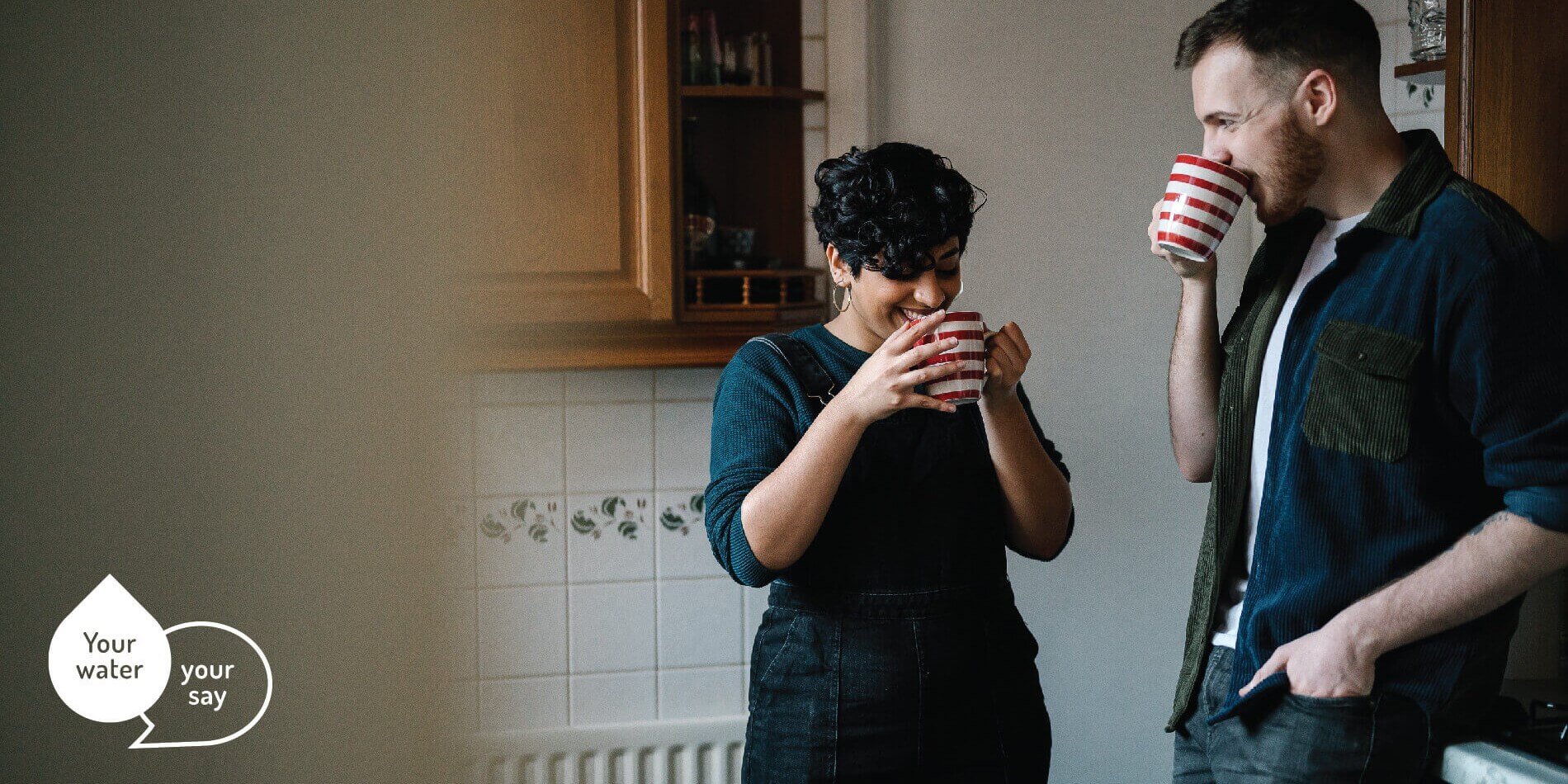 Couple in kitchen drinking cuppas