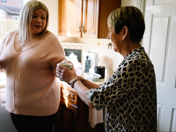 Two women in the kitchen with a cuppa